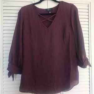 Deep purple shirt with tie cuff and criss cross chest detail. Small